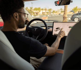 Man customizing his Tesla car with the help of his LCD screen