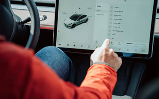 Person using the touchscreen inside a Tesla